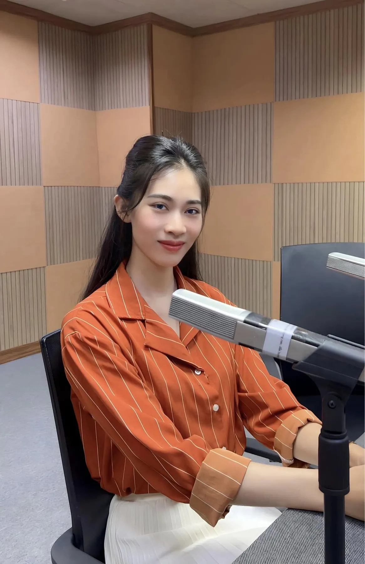 Bạch Quyên ngồi trước micro trong phòng thu